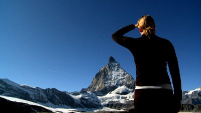 stock-footage-young-woman-climbing-to-the-mountain